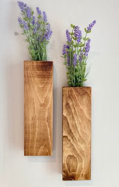 two wooden vases with purple flowers in them