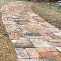 a brick path in the middle of a yard