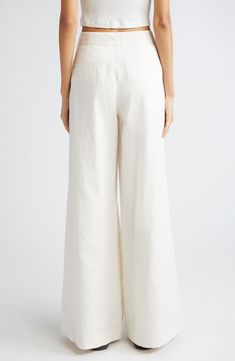 Dramatically flared wide legs lend runway-worthy movement to ultrahigh-waist pants softly kissed with fresh linen and cotton fibers. 32 1/2" inseam; 32" leg opening; 12" front rise; 15 1/2" back rise (size 8) Zip fly with hook-and-bar closure Front slant pockets 44% linen, 29% cotton, 27% lyocell Dry clean Made in the USA Elegant Wide Leg Cotton Pants, Chic Cream Wide Leg Full-length Pants, Chic Cream Full Length Wide Leg Pants, Full Length Cotton Wide Leg Pants, Chic High-waisted Flares For Summer, High Waist Cotton Flares For Summer, White Flare Wide Leg Pants For Work, Summer High Waist Cotton Flares, Summer High-waist Cotton Flares