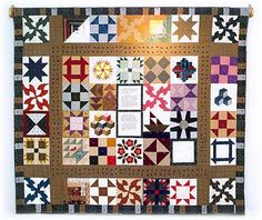 a wall hanging made up of different types of quilts