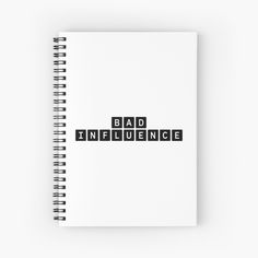 a spiral notebook with the words bad influence written in black on it, and an image of