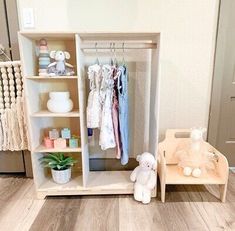 a baby's closet with clothes and toys in it