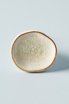 a small white bowl with a brown rim