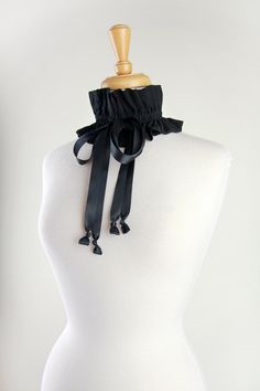 Complete your Victorian, Edwardian, or Regency inspired ensemble with a stylish black choker collar!!  Featuring an ethereal and soft rayon gauze fabric, cinched with double stain ribbon ties, this versatile neck ruffle makes it easy for you to create your own look on a historical fashion whim!! Wear it 4 different ways: *Gather up as a choker with ties in front or to one side. *Gather up as a choker with ties hanging down the back. *Loosen and wear as a statement necklace. *Loosen and wear as a collar with front ties. -100% Cotton gauze. -One size fits most. -This rayon gauze version is available in black and is ready to ship!!  -Choose from black, white, or ivory ties. -Many other colors are available in my cotton gauze: https://www.etsy.com/listing/1673476757/victorian-or-edwardian-coll Gothic Halloween Costume Choker, Fitted Vintage Costume Accessories For Cosplay, Halloween Gothic Costume Choker, Vintage Fitted Costume Accessories For Cosplay, Gothic Choker For Halloween Costume, Fitted Black Costume Accessories For Alternative Fashion, Black Steampunk Costume Accessories For Cosplay, Steampunk Black Costume Accessories For Cosplay, Black Choker For Alternative Fashion