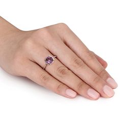 Classic and elegant, this exquisite ring makes a thoughtful gift for the February birthday girl. Created in warm 10K rose gold, this ring showcases a 7.0mm bright purple amethyst center stone in a traditional four-prong setting bordered with shimmering diamond accents. Additional diamond accents sparkle along the slender shaft. Visually stunning and sure to be a go-to favorite, this ring is polished to a bright shine. February Birthday, Bright Purple, Birthday Girl, Purple Amethyst, Prong Setting, Girl Birthday, Thoughtful Gifts, Engagement Ring, Amethyst