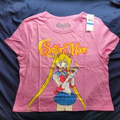 This Nwt Juniors Xl Crop Short Sleeve T-Shirt In Pink Features A Graphic Of Our Favorite Pretty Guardian Sailor Moon. This Is Officially Licensed And Is Made Of 50% Cotton And 50% Polyester. It Measures About 18.5 Inches Pit To Pit When Laid Flat. Measurments Are Approximate. I Am Open To Offers And I Encourage Bundles To Save On Shipping. Please Let Me Know If You Have Any Questions. Thank You! 90s Crew Neck Top With Character Print, 90s Short Sleeve Tops With Character Print, Pink Relaxed Fit Top In Pop Culture Style, Pink Relaxed Fit Top For Pop Culture, Pink Pop Culture Tops For Summer, Pink Pop Culture Tops For Spring, Spring Pink Pop Culture Tops, Pretty Guardian Sailor Moon, Cropped T Shirt