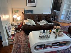 a living room filled with furniture and lots of clutter on top of a rug