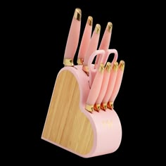 a pink and gold knife holder with six knives