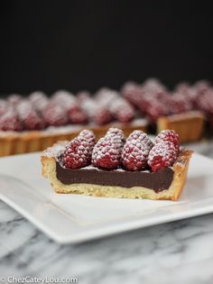 a piece of cake topped with raspberries on top of a white plate