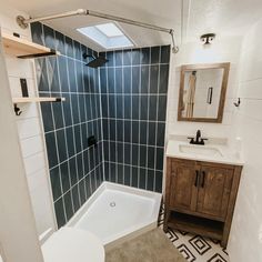 a bathroom with a toilet, sink and bathtub next to a mirror on the wall