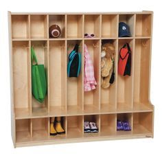 a child's wooden locker with shoes and umbrellas