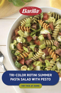 a white bowl filled with pasta salad on top of a table