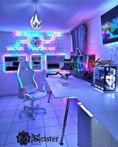 a room that has some lights on the walls and chairs in it, with two computer monitors