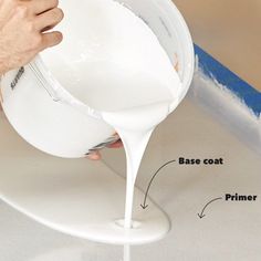 a person pouring white liquid into a bowl on top of a counter with the words base coat and primer