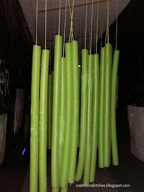 several green candles are hanging from the ceiling