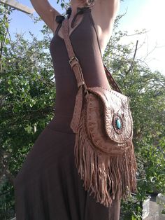 "Boho purse, Leather Fringe Bag, Fringe shoulder Bag, Brown Leather, Turquoise Stone, Hippie Bag, Boho Bag, Ibiza Bag, Handmade Bag Light Brown leather bag with fringe and Turquoise Stone Fully lined inside with one pocket and a inside pocket with zip. Strap can be adjustable to several lengths. Handmade and the best finishing quality. Dimensions: Main pocket with brass magnet: [10\"X9.5\"] or [26cmX24cm] Inside zipper pocket: [5\"x5\"] or [13x13cm] Fringe [8.5\"] or [22cm] Notes: 1) Since every Bohemian Crossbody Saddle Bag For Everyday Use, Bohemian Satchel Saddle Bag For Travel, Bohemian Saddle Shoulder Bag For Travel, Bohemian Saddle Bag With Adjustable Strap For Travel, Bohemian Saddle Bag With Adjustable Strap For Daily Use, Bohemian Saddle Tote Bag For Everyday Use, Bohemian Tote Saddle Bag For Everyday Use, Bohemian Satchel Saddle Bag For Daily Use, Bohemian Handheld Shoulder Bag With Removable Pouch