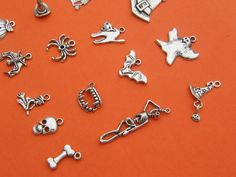 16 Different antique silver tone charms make up this set, ranging from 18 to 42mm Metal Nickel-free Silver Novelty Charms, Nickel Free Silver Themed Charms, Nickel-free Silver Themed Charms, Nickel-free Themed Silver Charms, Themed Silver Metal Charms, Halloween Silver Charm Jewelry, Silver Halloween Charms Jewelry, Silver Halloween Jewelry With Charms, Halloween Charms