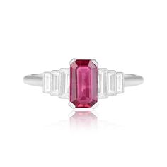 a pink tourmaline and white topazte ring with baguets on the side