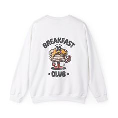 Flip into comfort with our Cute Pancake Graphic Crewneck Sweatshirt! Featuring an adorable pancake design, this cozy crewneck is perfect for breakfast lovers and brunch enthusiasts who want to start their day with a smile. Product Details This Gildan unisex heavy blend crewneck sweatshirt is made from polyester and cotton. The collar is ribbed knit, so it retains its shape even after washing. There are no itchy side seams on these sweaters.  - 50% cotton, 50% polyester - Medium-heavy fabric - Loose fit - Sewn-in label - Runs true to size, recommend sizing up 1 or 2 sizes for a loose fit --- No returns or exchanges --- Breakfast sweatshirt, graphic crewneck, retro style sweater, unisex sweatshirt, cozy crewneck, vintage-inspired top, morning outfit White Cartoon Print Sports Top, White Cartoon Print Tops For Sports, White Sporty Sweatshirt With Cartoon Print, White Graphic Print Sweatshirt For Workout, Pancake Designs, Cute Breakfast, Morning Outfit, Breakfast Lovers, Sweatshirt Graphic