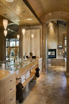 a large bathroom with two sinks and mirrors