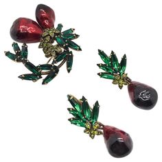 A fabulous vintage Hobe Brooch & Earrings. Featuring a stunning combination of stones. Including emerald green marquise and lime green stones leading to the dramatic contrast of the red enamel pear shaped drops. The lustrous red enamel is a stunning feature and very unusual, flowing from a very light almost luminescent red, through to burgundy. Hobe were top class mid century costume jewellery makers and thier craftmenship second to none. In very good vintage condition and signed. The brooch mea 1960s Earrings, Costume Jewelry Makers, Jennifer Gibson, Valentino Couture, Fruit Earrings, Chanel Vintage, Crystal Set, Vintage Jewels, Jewelry Companies