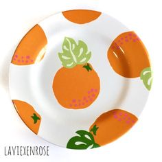 a plate with oranges painted on it