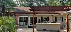 an outdoor kitchen and grill area in the back yard