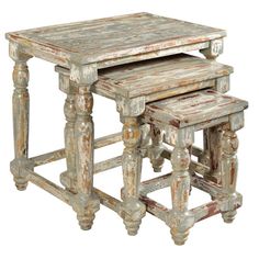 an old wooden table with two stools