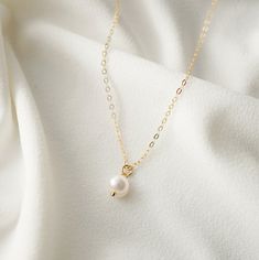 "A single creamy and iridescent pearl - the essence of a classic piece. Dainty and modern, on a on a fine 14K gold fill chain. Pearls symbolize wisdom acquired through experience. The pearl is also said to symbolize the purity, generosity, integrity, and loyalty of its wearer. Pearl is the birthstone for June. *Free shipping for orders to USA and Canada, and no duties and customs fees.* > This pearl is organically shaped so may not be a perfect sphere > Shown worn on a 16\" gold cable chai Popular Necklaces, Pearl Necklace Designs, Iridescent Pearl, Necklace Extender, Pearl Cream, June Birthstone, Girly Jewelry, June Birth Stone, Gold Filled Jewelry