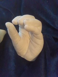 two hands that are holding something in each other's palm and one hand with an extended thumb