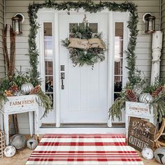 the front door is decorated for christmas with wreaths and pine cones