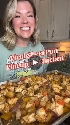 a woman standing in front of a pan filled with chicken and vegtables