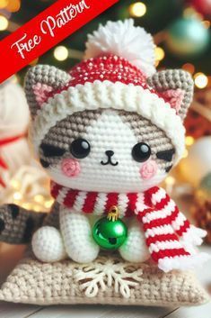 a crocheted christmas ornament with a cat wearing a hat and scarf