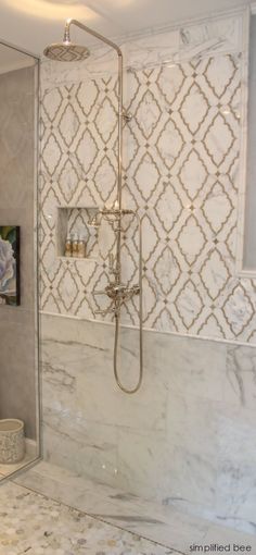 a bathroom with a walk in shower next to a sink