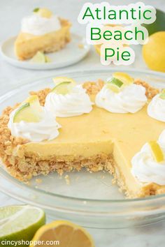 a close up of a pie on a plate with lemons and limes in the background