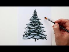 someone is drawing a christmas tree on paper