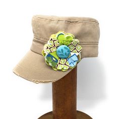 "Need that something extra to accessorize your day?  These cadet caps are the answer.  With an adjustable back, these caps fit most women and even some young girls.  Great for a bad hair day, post- workout, vacation or just for something cute, these hats are adorned with a removable fabric flower pin. Why a pin?  Well maybe you just want a plain hat - or maybe to change the pin (see our shop for more flower pins available).  Maybe you don't want to wear the cap but want to use the flower to acce Vintage Adjustable Khaki Hat, Military Style Camouflage Flat Cap, Khaki Military Baseball Cap For Sports, Embroidered Flower Baseball Cap, One Size, Fabric Flower Pins, Khaki Cotton Military Baseball Cap, Scarf Jacket, Girls Bib, Drool Bib