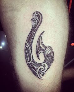 a black and white tattoo on the leg of a man's leg with an ornamental design