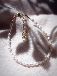 This beaded anklet features a collection of tiny white freshwater pearls to capture the enticement of Hawaii’s white sand beaches. Wear this gold pearl anklet alone or stacked for a classically elegant allure. ✦ DETAILS ✦✧ Name: Maile (MIE-leh) - vine.✧ Adjustable Length up to 10" Inches.✧ White 2-3mm Freshwater Pearls.✧ 14kt Gold Filled Components, Extender, and Clasp.✧ All Ke Aloha Jewelry pieces come packaged thoughtfully, beautifully, and ready for gift giving. Adjustable White Pearl Anklets, Delicate White Anklet As A Gift, Adjustable White Pearl Chain Anklet, White Anklets With Pearl Charm As Gift, Tiny Beads Pearl Bracelet, Adjustable Dainty Pearl Anklets, Gold Pearl Anklet With Pearl Charm, Gold Pearl Anklets As Gift, Gold Pearl Anklets For Gift