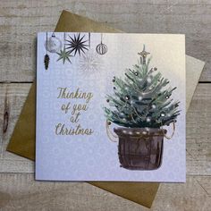 a greeting card with a christmas tree in a pot