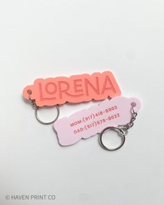 two personalized keychains with the name lorena on one and an id tag on the other