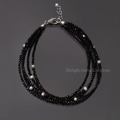 Product Details :  ITEM : BLACK SPINEL BEADED BRACELET Item Code : DGC4641 Gemstone Name :  BLACK SPINEL No. of Strand : 5 STRAND BRACELET Chain Style : BEADED Beads Shape : MICRO FACETED ROUND Beads Size : 2 mm Approx. Length : 8 INCH INCLUDING THE LOBSTER CLASP Weight : 30 Cts. Approx. Customization : **Available** Please Feel Free To Contact If You Have Any Query. Luxury Black Single Strand Jewelry, Elegant Luxury Black Spinel Jewelry, Black Bracelets With Faceted Round Beads, Elegant Black Tiny Beads, Elegant Black Bracelets With Faceted Beads, Adjustable Black Pearl Bracelet, Elegant Handmade Black Beaded Bracelets, Black Beaded Rondelle Jewelry, Elegant Multi-strand Tiny Beaded Bracelets