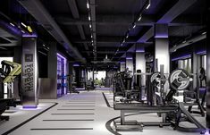 an empty gym with rows of exercise machines