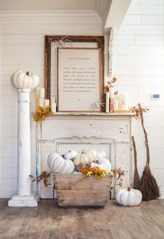 a white fireplace with pumpkins and candles on it in front of a framed poem