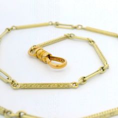 Material: 12k-14k Yellow Gold Weight: 8.09 Grams Chain Type: 13.75" - Elongated link - Spring Ring Clasp Thickness: 2.58mm (approx.) Condition: Overall finish & patina preserved. Excellent physical condition. Stock Number: JO-09039231-04202411-PAR Engraved Yellow Gold Chain Link Jewelry, Engraved Chain Link Jewelry For Formal Occasions, Formal Engraved Jewelry With Rectangular Links, Engraved Yellow Gold Chain Link Necklace, Formal Etched Yellow Gold Necklace, Formal Yellow Gold Etched Necklace, Engraved Chain Link Necklace For Formal Occasions, Formal Engraved Chain Link Necklace, Formal Engraved Link Necklaces