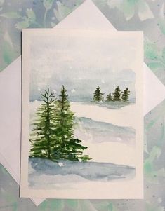 a card with watercolor painting of trees in the snow