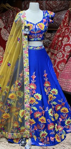 Royal blue summer blossom pattern with colorful flowers hand embroidered patchwork design lehenga. Available with matching embroidered blouse and contrasting light yellow embroidered net dupatta. All you need to slay that perfect look and this is how! Fabric : Silk Size: 38 Ready to Ship! Floor-length Lehenga With Multicolor Embroidery For Diwali, Semi-stitched Floral Embroidered Dress For Navratri, Semi-stitched Floral Embroidery Dresses For Navratri, Floral Embroidered Semi-stitched Dress For Navratri, Semi-stitched Floral Embroidery Dress For Festivals, Semi-stitched Bollywood Choli With Floral Embroidery, Floor-length Floral Embroidery Set For Festivals, Designer Yellow Saree With Floral Embroidery, Semi-stitched Yellow Saree With Floral Embroidery