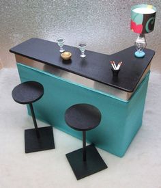 an ice cream cart with three stools next to it and a lamp on top