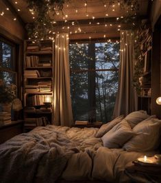 an unmade bed with lights hanging from the ceiling and bookshelves above it