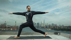 a man doing yoga on top of a roof